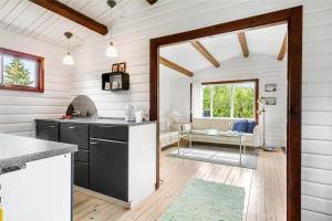 a kitchen with white walls and a wooden floor at FA043-Faxe-Ladeplads-Svend-Gongesvej-4 in Fakse Ladeplads