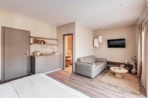 a living room with a couch and a chair at Iroon Units in Ermoupoli
