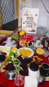a table with plates of food on a table at HOSTEL RAIZ da BAHIA Antigo Hostel Torre in Salvador +34 photos