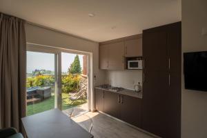 a kitchen with a large sliding glass door to a patio at Camping Village Panoramico Fiesole in Fiesole