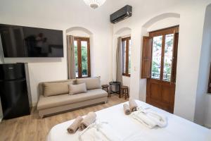 a living room with two beds and a couch at La Casa di Symi - Central Apartment with View in Symi