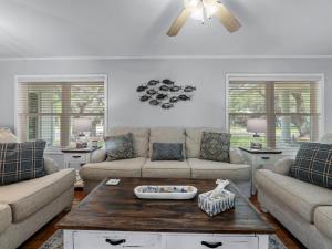 a living room with two couches and a coffee table at The Sea Glass House in Rockport