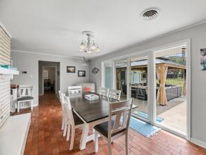 a dining room and living room with a table and chairs at The Sea Glass House in Rockport