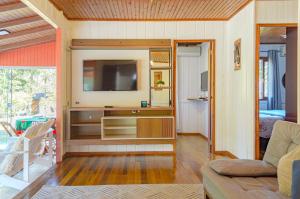 a living room with a tv and a couch at Casa de campo c lareira, jogos e piscina aquecida in Annitapolis