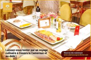 a table with plates of food on it at Grand Hôtel City - Akwa in Douala