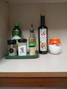 a shelf with a bottle and other ingredients on it at Appartamento Grifo in Vernazza