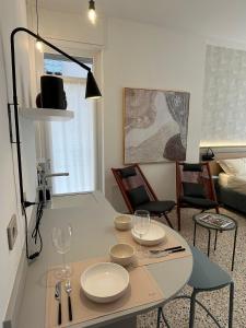 a living room with a table with plates and glasses on it at Residenza Tonale in Verona