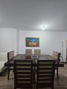 a dining room table with chairs and a painting on the wall at Casa Lina in Boca Monte +4 photos