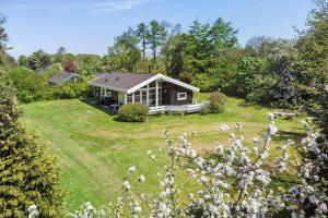 a small house in a field with a yard at 1080-Stege-Berberisvej-48 in Stege