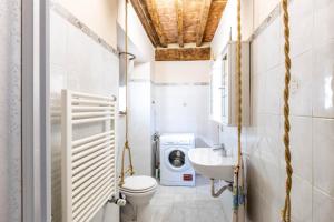 a bathroom with a washing machine and a washer and dryer at La Casina Di Wendy in Sassa +41 photos