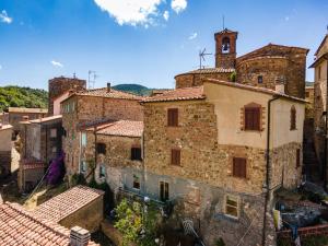 an aerial view of an old stone building with a clock tower at La Casina Di Wendy in Sassa