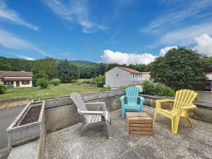 three chairs sitting on top of a roof at Chez Françoise Campagne Clim Fontfreyde in Saint-Genès-Champanelle