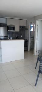 a kitchen with a counter and a chair in a room at Studio Iracema 2001 in Fortaleza