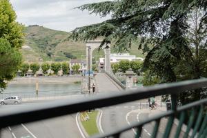 a view from a balcony of a street with a car at BaliRhône - Spa privé & balcon avec vue in Tournon-sur-Rhône