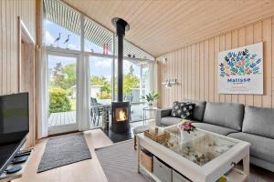 a living room with a couch and a fireplace at 1060-Stege-Ulvshalevej-213 in Stege