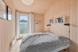 a bedroom with a bed in a room with a window at 1060-Stege-Ulvshalevej-213 in Stege