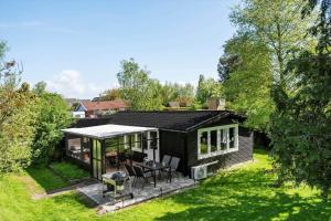 a small house with a table and chairs in a yard at S722-Stroby-Ladeplads-Svalemosevej-36 in Strøby Ladeplads