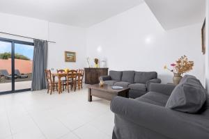 a living room with a couch and a table at Home2Book Chill BBQ Hideaway in Corralejo in Corralejo