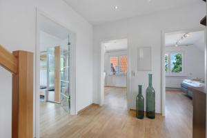 a living room with two green glass bottles on the floor at To Hus an´t Water in Wunstorf +21 photos