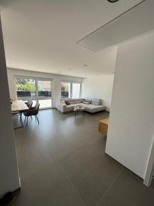 a living room with a couch and a table at Stilvolle Penthouse Wohnung in Horb am Neckar