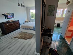 a bedroom with a bed and a dresser and a mirror at Sweet Home Inn in Świnoujście +21 photos