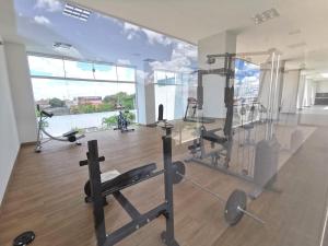 a gym with cardio equipment in a large room at Mi casa, su casa - Moderno y Chic in Santa Cruz de la Sierra