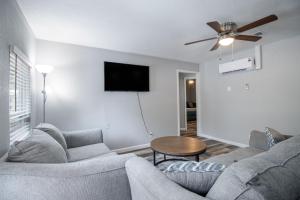 a living room with a couch and a table at Coastal Haven by Next Step Property Management in Gulfport
