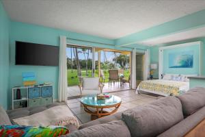 a living room with a couch and a bed at Keauhou Palena 901 in Kailua-Kona
