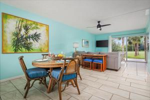 a living room with a table and chairs at Keauhou Palena 901 in Kailua-Kona