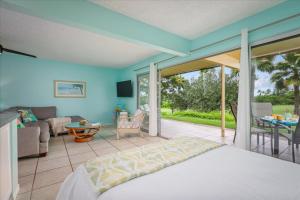 a bedroom with a bed and a living room at Keauhou Palena 901 in Kailua-Kona +32 photos