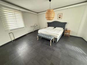a bedroom with a bed and a bench in it at Home in Attnang-Puchheim