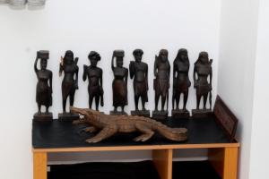 a figurine of a group of people and a dinosaur on a table at Blue Moon Villa in Waskaduwa +39 photos