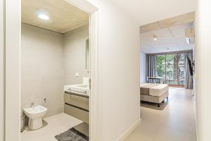 a bathroom with a toilet and a bed in a room at Deluxe Recoleta Apartments - By Magno in Buenos Aires +152 photos