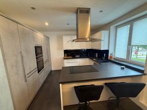 a kitchen with a counter and two chairs in it at Home in Attnang-Puchheim