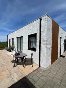un patio con tavolo e un edificio di Tulip Lodges a Voorhout