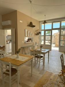 a kitchen and dining room with a table and chairs at Otto Trulli Apulian Country House in Noci