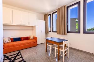 a living room with a couch and a table at Via Moro - Home 47 in Quarto dʼAltino