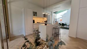 una cucina con mobili bianchi e un piano di lavoro di Villa Luxe-bord de mer-hyper centre Art Deco a Le Touquet-Paris-Plage
