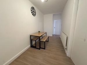 WoolwichにあるStylish 1-bedroom apartmentのテーブルと時計付きの部屋