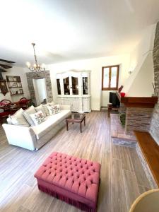 a living room with a white couch and a red stool at DIMORA San Secondo 17D in Gubbio