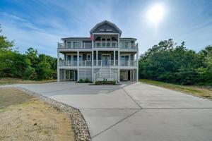 a large white house with a flag on it at Walk to Beach Southern Shores Retreat with Hot Tub in Kitty Hawk