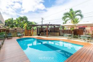 a swimming pool in the middle of a wooden deck at CPR - Apartamentos a 200m da praia com Piscina in Marau