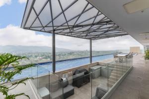 a view of a swimming pool from a house at Urban Breeze iFreses, 10th floor! AC, TV and Pool in Guayabos