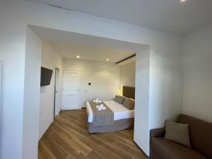 a hotel room with a bed and a couch at Relais Villa Verde in Ventotene