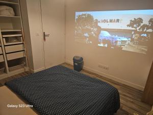a room with a poster of a car on the wall at Emmanuel INN 3 in Drancy