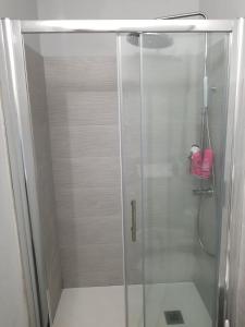 a shower with a glass door in a bathroom at Home on Via degli Dei, Close to Florence in Osteria di Novoli