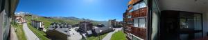a view of a city from a window of a building at Le Serac Panoramic Mountain View spacious 40m2 managed by private host in Val Thorens