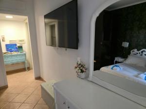 a bedroom with a bed and a large mirror at Il Bacio di Roma in Infernetto