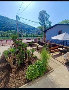 a park with benches and plants and a building at Studio Palma in Zvornik