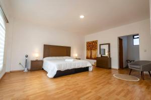 a bedroom with a bed and a desk and a chair at Casa Ambito in San Raymundo Jalpan +53 photos